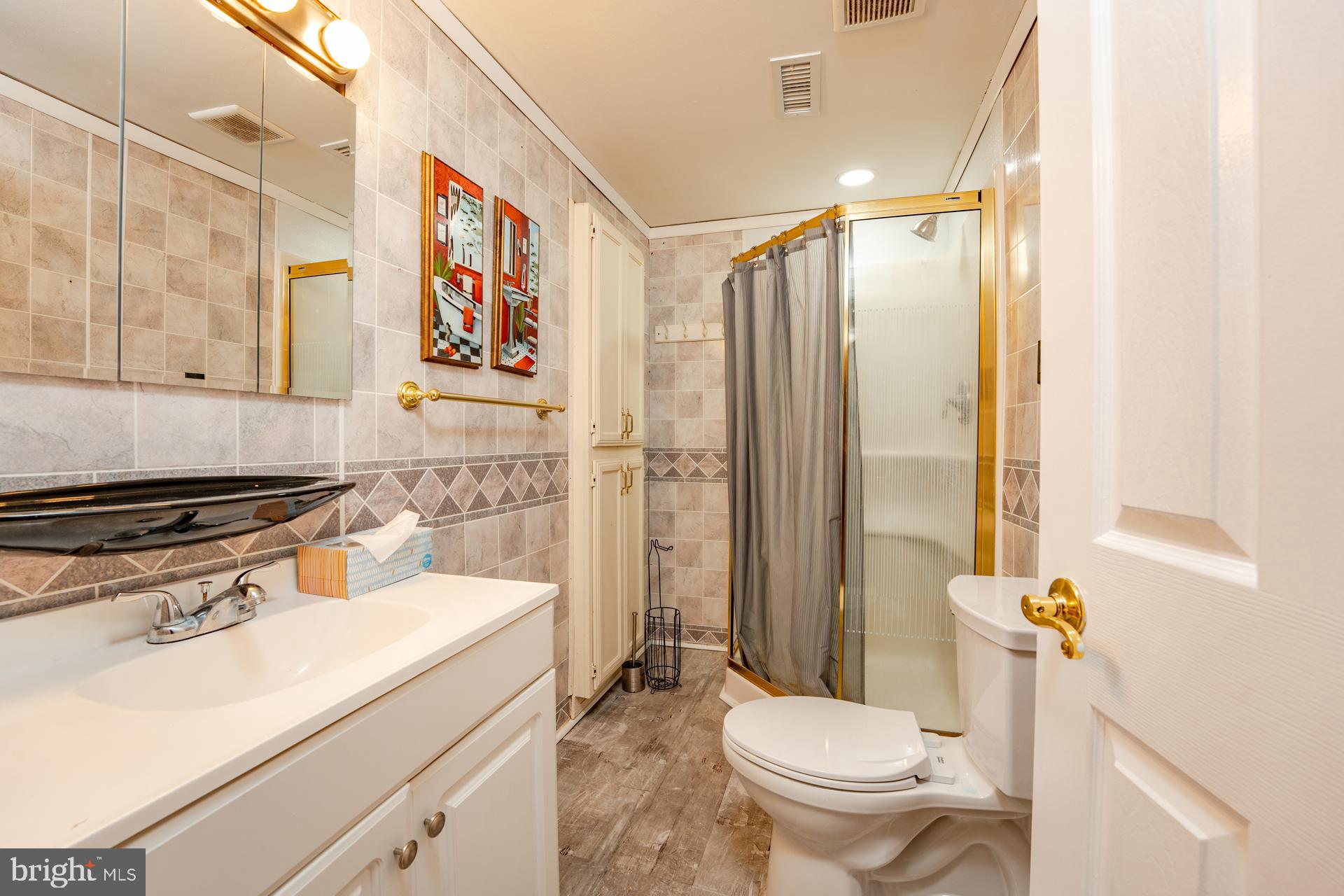 254 Vail Court, Unit 1504 Mays Landing, NJ 08330 - Photo 17 of 22 a bathroom with a sink toilet and shower
