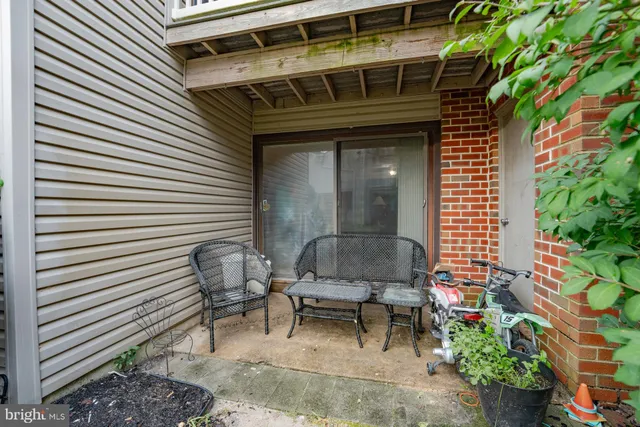a view of a house with plants and chairs