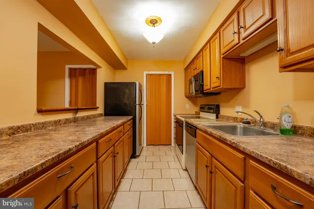 a large kitchen with a sink and cabinets