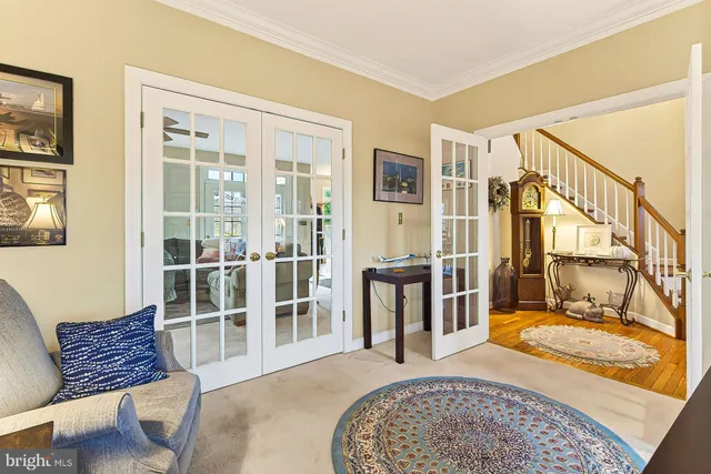 a view of a house with a yard and large trees