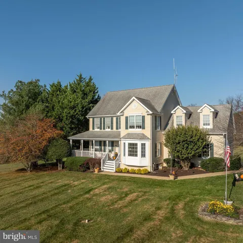 a view of a house with swimming pool and sitting area