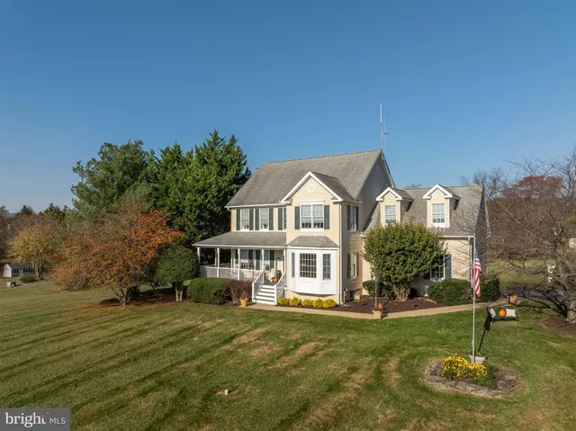 a view of a house with backyard porch and sitting area