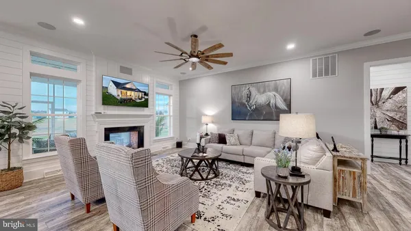 a living room with furniture a flat screen tv and a fireplace