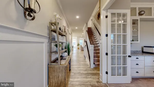 a view of a hallway with wooden floor and entryway