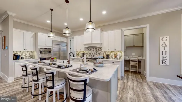 a large kitchen with a table and chairs