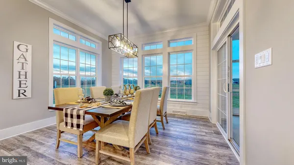 a view of a dining room with furniture wooden floor and chandelier