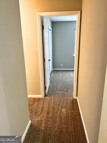 a view of hallway with wooden floor