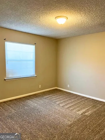 an empty room with a empty space and windows