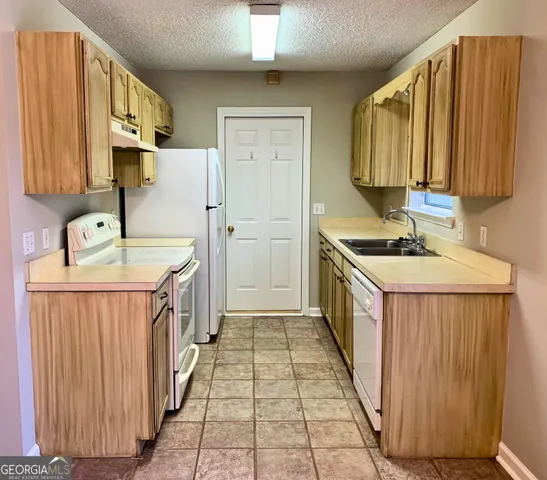 a kitchen with a sink stove and cabinets
