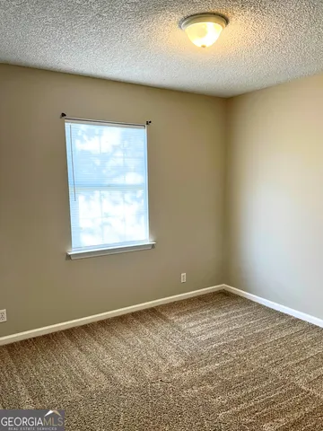 an empty room with a chandeliers