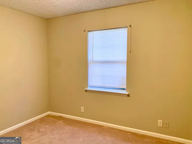 a view of a small space with a wooden floor and a window