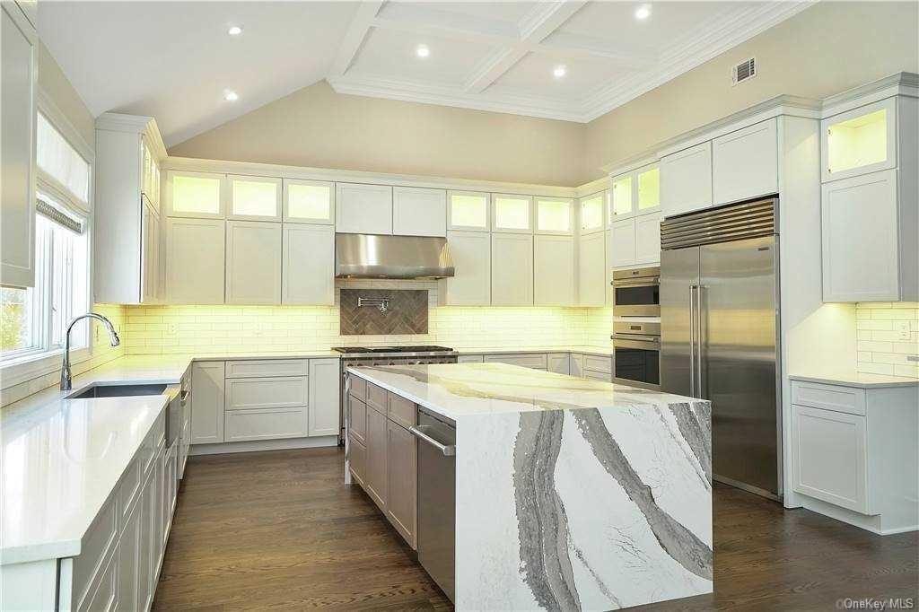 Lot 2 Wading River Road Manorville, NY 11949 - Photo 11 of 28 Kitchen with light stone countertops, a center island, range hood, stainless steel built in refrigerator, and white cabinets. FOR MARKETING PURPOSES ONLY!