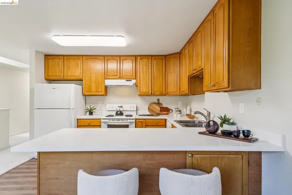 a kitchen with a sink a stove and cabinets