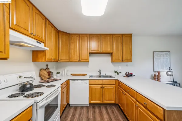 a kitchen with a sink a stove and cabinets