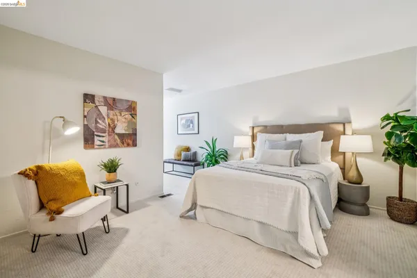 a bedroom with a bed and a chair