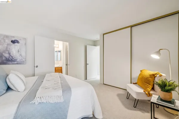 a bedroom with a bed window and chair