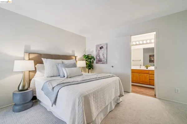 a bedroom with a bed and a lamp