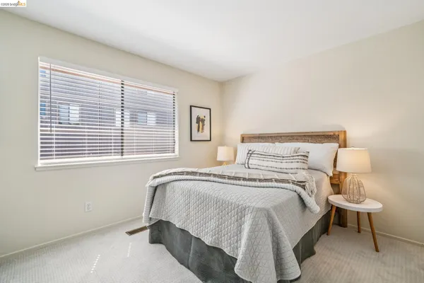a bedroom with a bed and a lamp