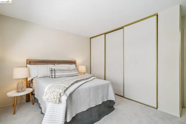 a bedroom with a bed and a night stand