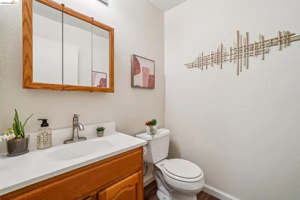 a bathroom with a sink a toilet and mirror