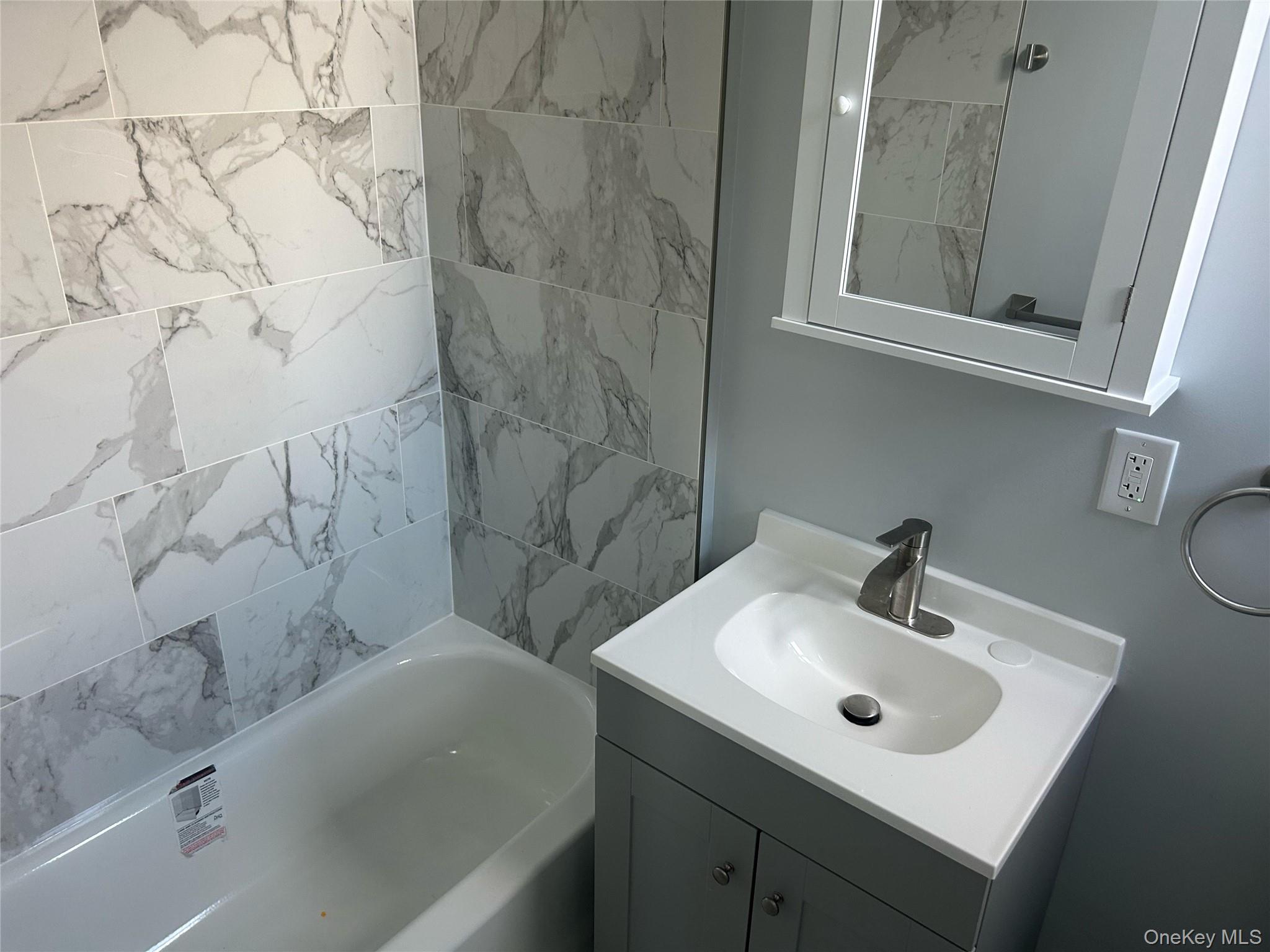 88-23 85th Street, Unit 2R Queens, NY 11421 - Photo 14 of 14 a bathroom with a sink and a mirror