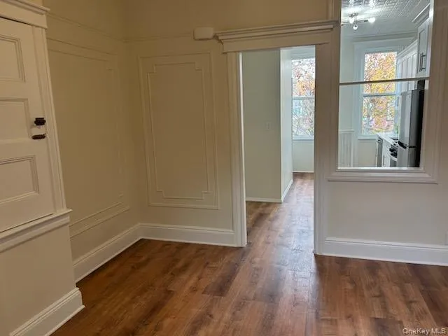 a view of a room with wooden floor and windows