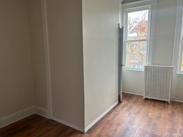 88-23 85th Street, Unit 2R Queens, NY 11421 - Photo 6 of 14 a view of an empty room with wooden floor and a window