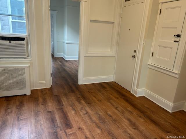 88-23 85th Street, Unit 2R Queens, NY 11421 - Photo 8 of 14 an empty room with wooden floor and entrance