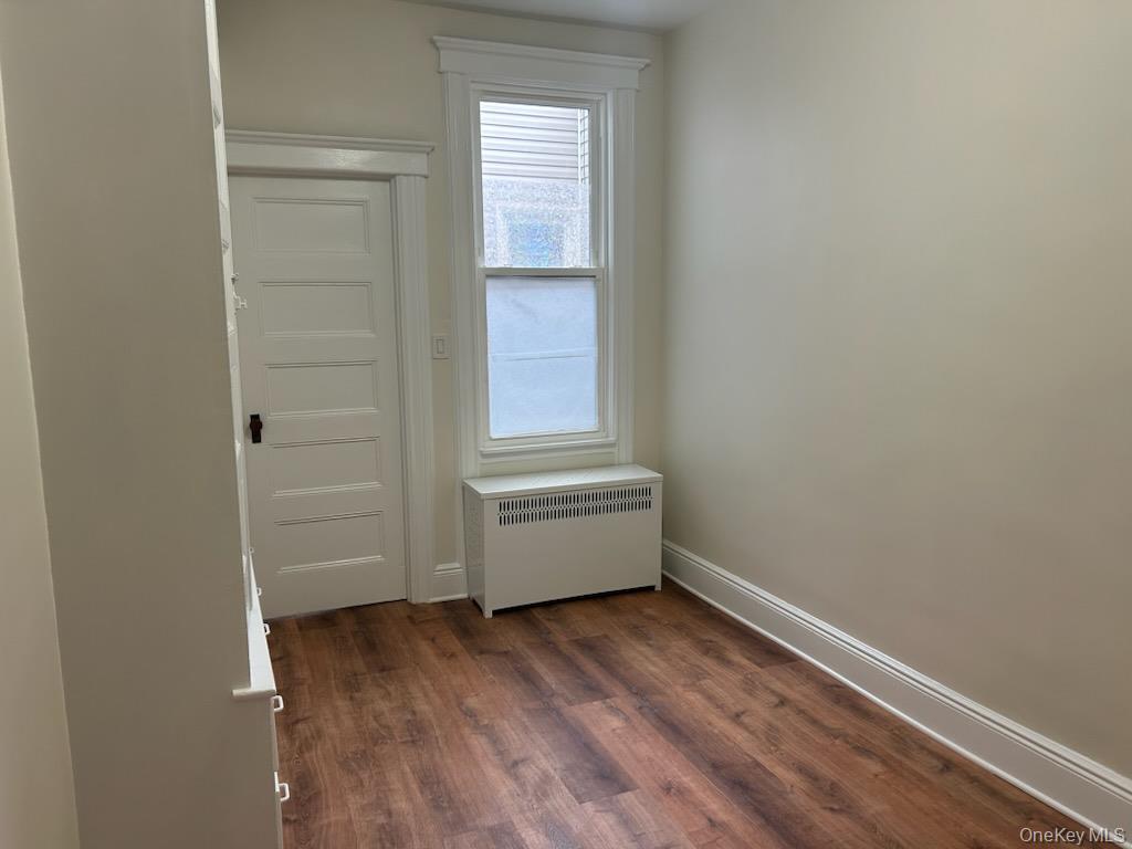 88-23 85th Street, Unit 2R Queens, NY 11421 - Photo 10 of 14 a room with a wooden floor and a window