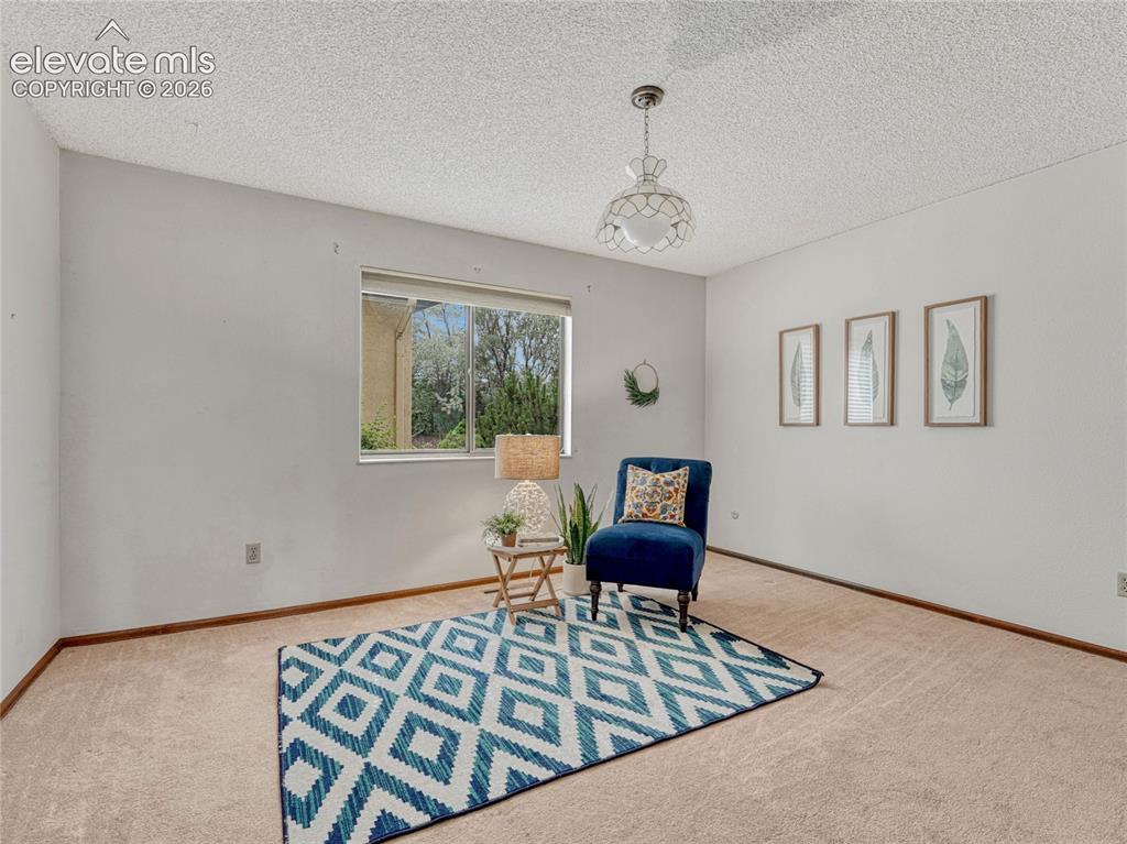 1146 Fontmore Road, Unit A Colorado Springs, CO 80904 - Photo 22 of 24 a view of a livingroom with lounge chair and a window