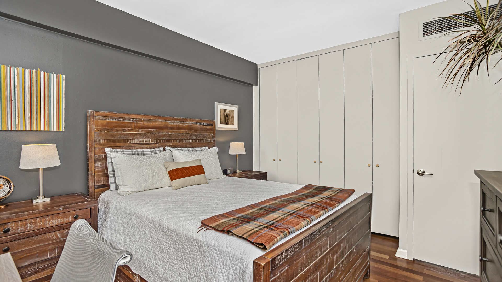 Undisclosed Address Chicago, IL 60657 - Photo 15 of 23 a bedroom with a bed and a potted plant on the dresser