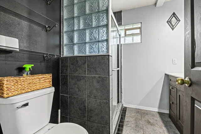 a bathroom with a toilet and a shower