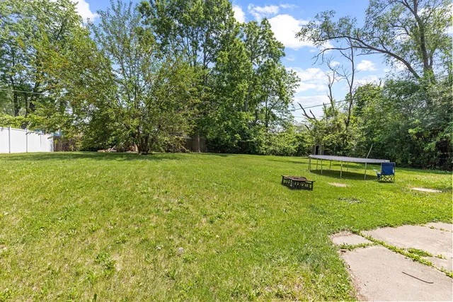a view of a field of grass and trees