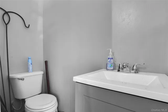 a bathroom with a sink a toilet and a mirror