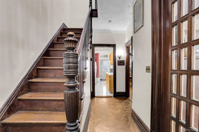 a view of staircase with white walls and a window
