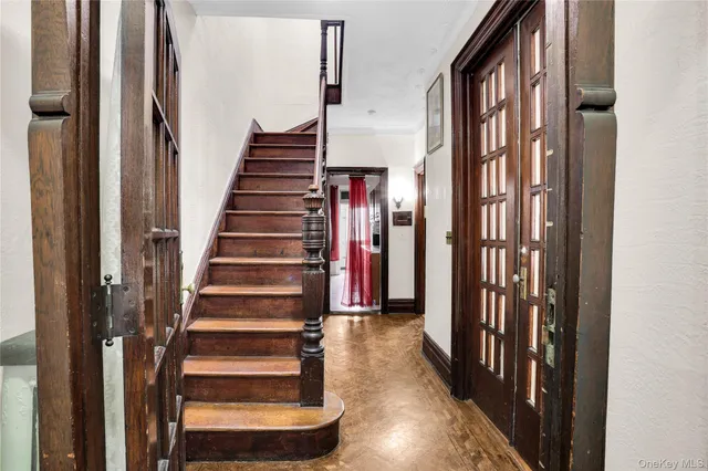 a view of a hallway with wooden floor and entryway