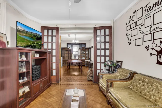 a living room with furniture a flat screen tv and a floor to ceiling window