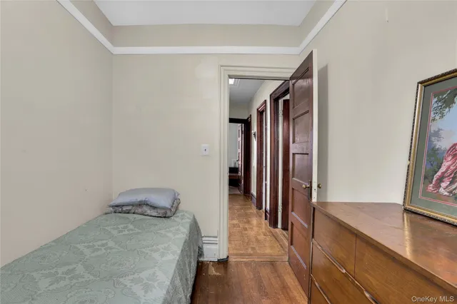 a hallway with wooden floor and stairs