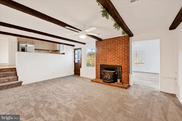 an empty room with fireplace and window