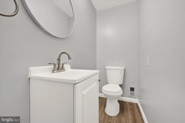 a bathroom with a toilet sink and a mirror