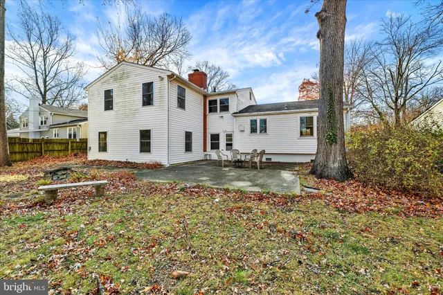 a view of a white house with a yard