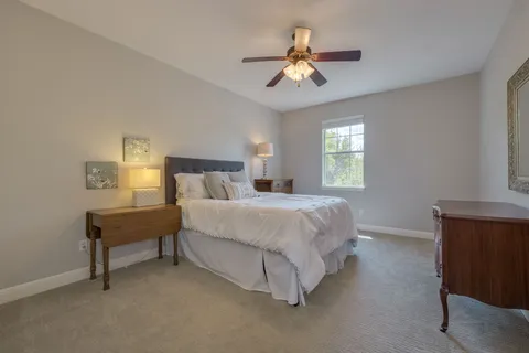 a spacious bedroom with a bed and window
