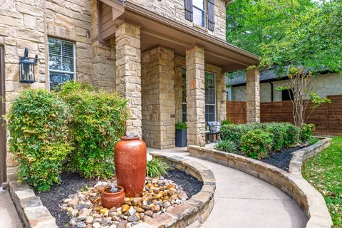 a view of a patio with table and chairs potted plants
