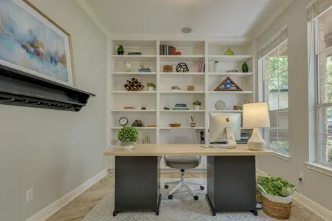 a view of a dining room with furniture and window
