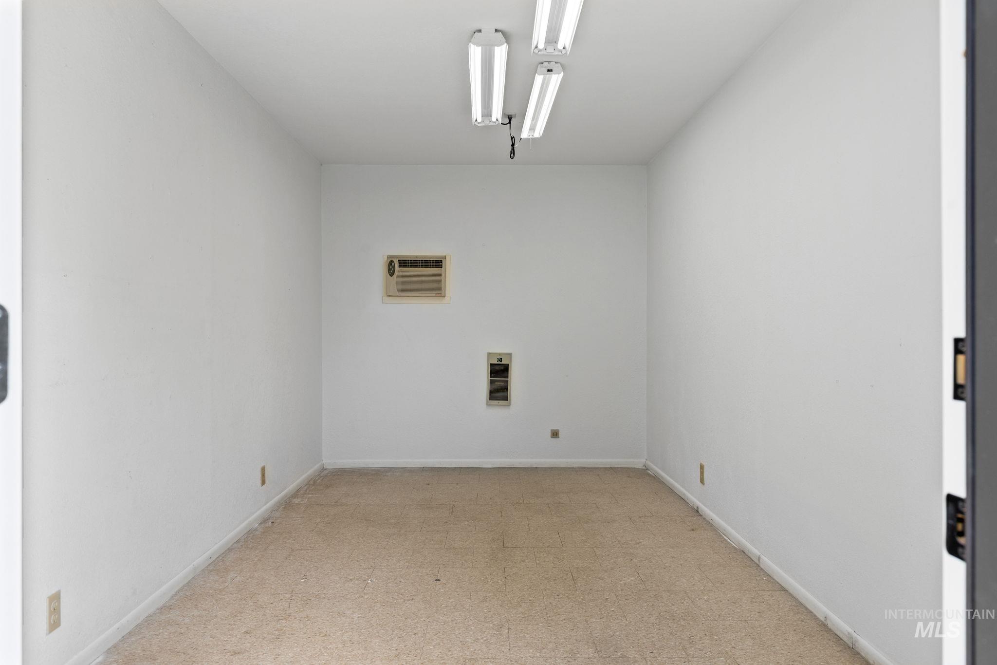 1675 Country Terrace Way Meridian, ID 83642 - Photo 39 of 50 Carpeted flooring, white painted walls, fluorescent ceiling lighting, wall-mounted air conditioning unit, and a wall heater