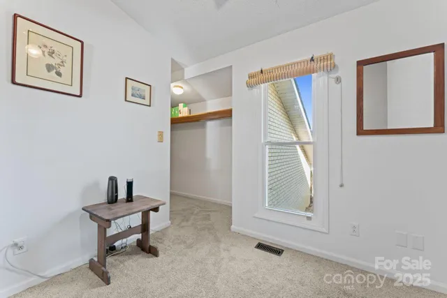 a room that has a window and a table in it