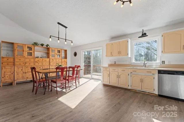 a kitchen with stainless steel appliances a refrigerator sink and cabinets