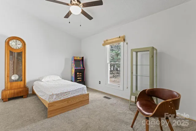 a bedroom with a bed and a chair