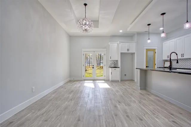 a view of kitchen with refrigerator stove and a sink