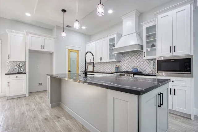 a view of a kitchen with a sink and wooden floor